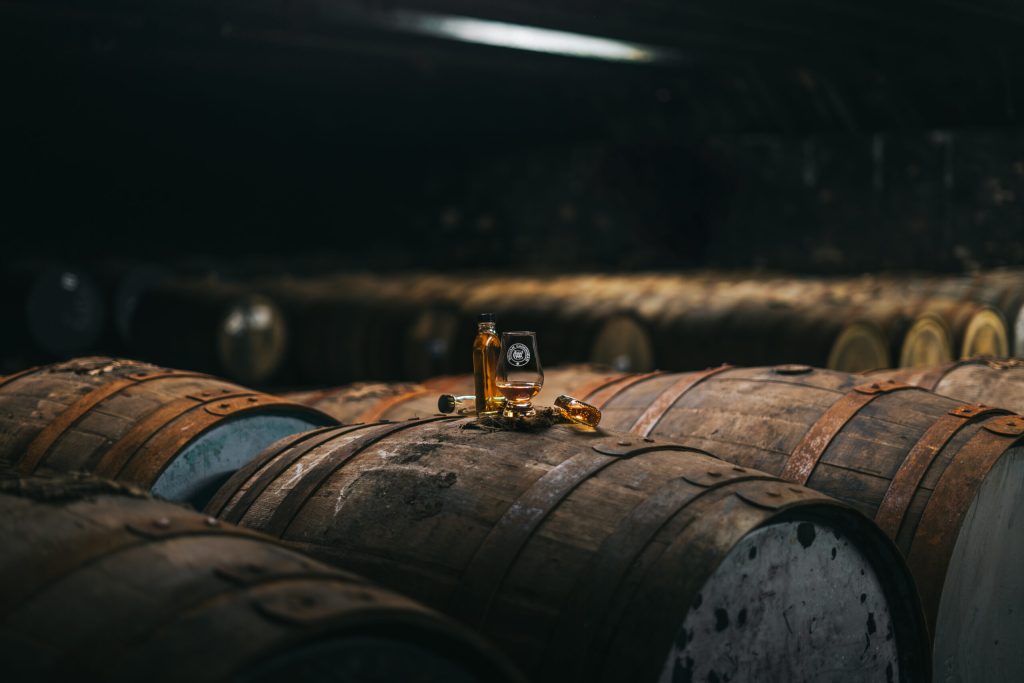 A Glencairn glass resting on a cask in the Cadenhead's warehouse